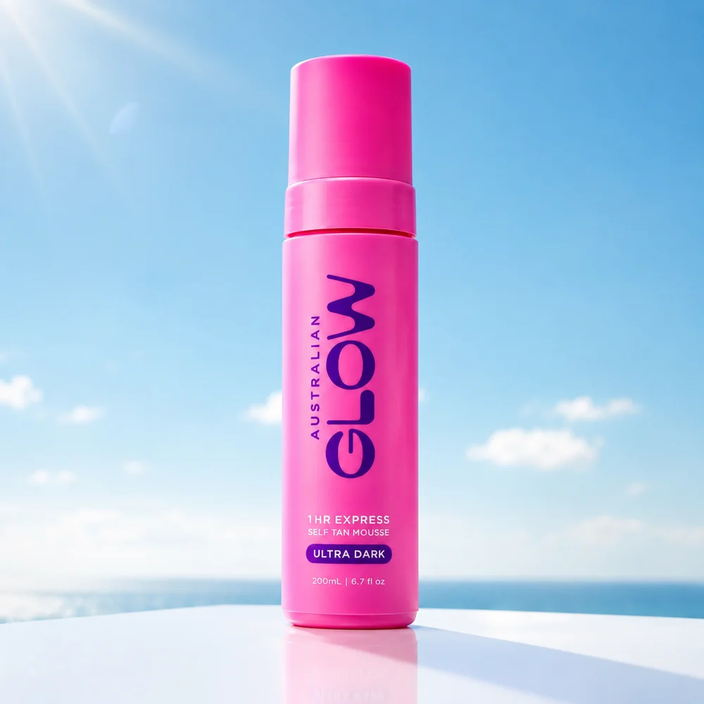 Australian Glow 1HR Express Ultra Dark self-tan mousse on a sunlit ledge above the ocean