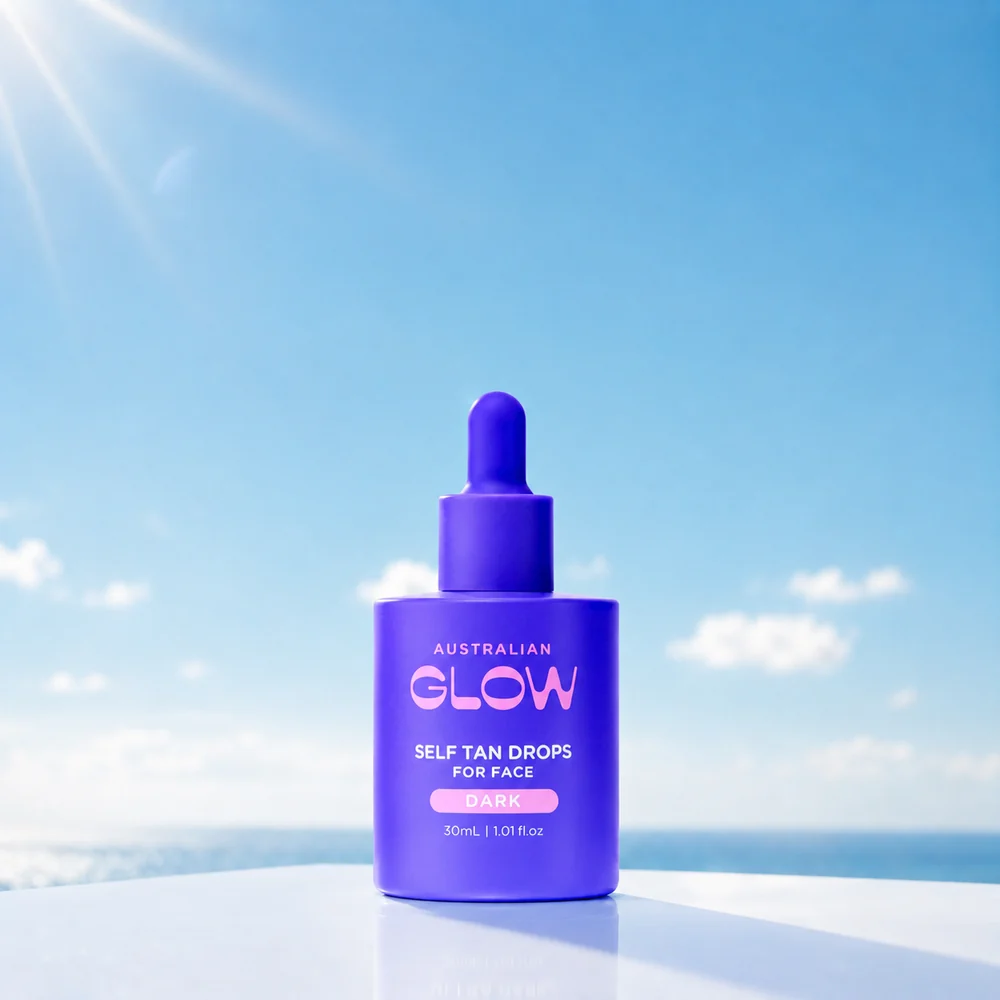 Australian Glow Self Tan Drops for Face in Dark on a white ledge above the sea