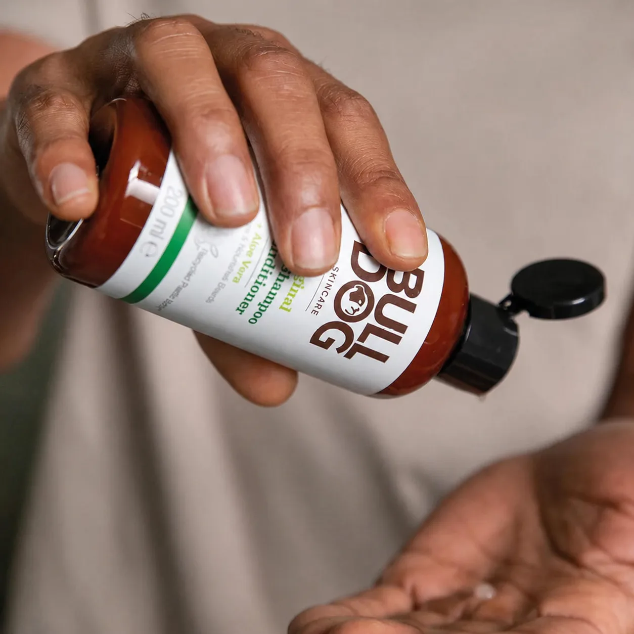 A man pouring Bulldog into his hand, the product in use