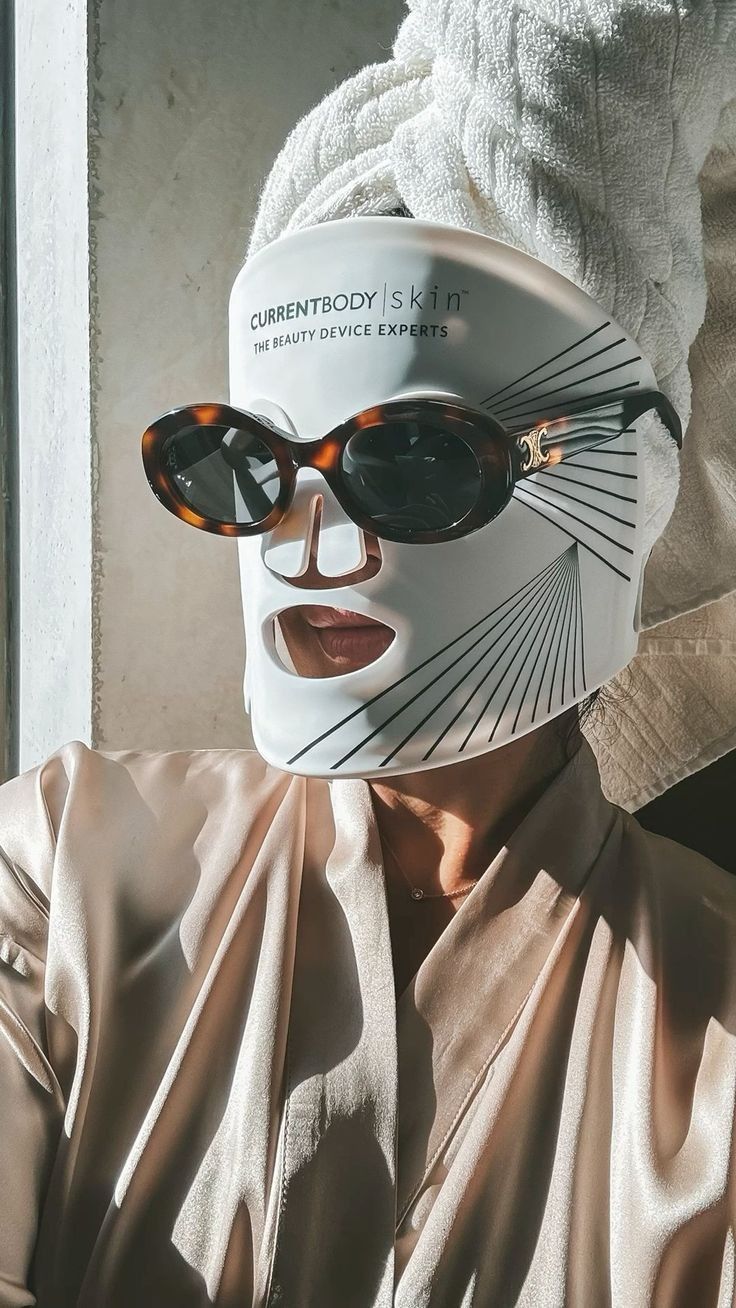 CurrentBody Skin LED Mask worn with hair towel and silk robe, the at-home ritual