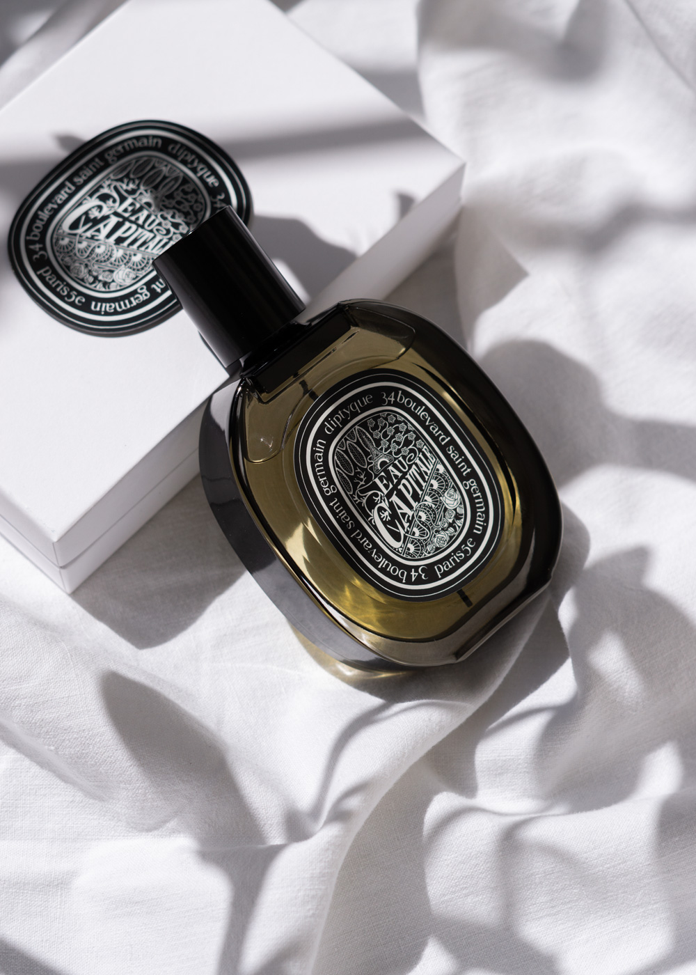 Diptyque Eau Capitale Eau de Parfum on linen
