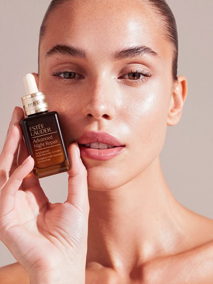 Estée Lauder Advanced Night Repair held to model's face, campaign portrait