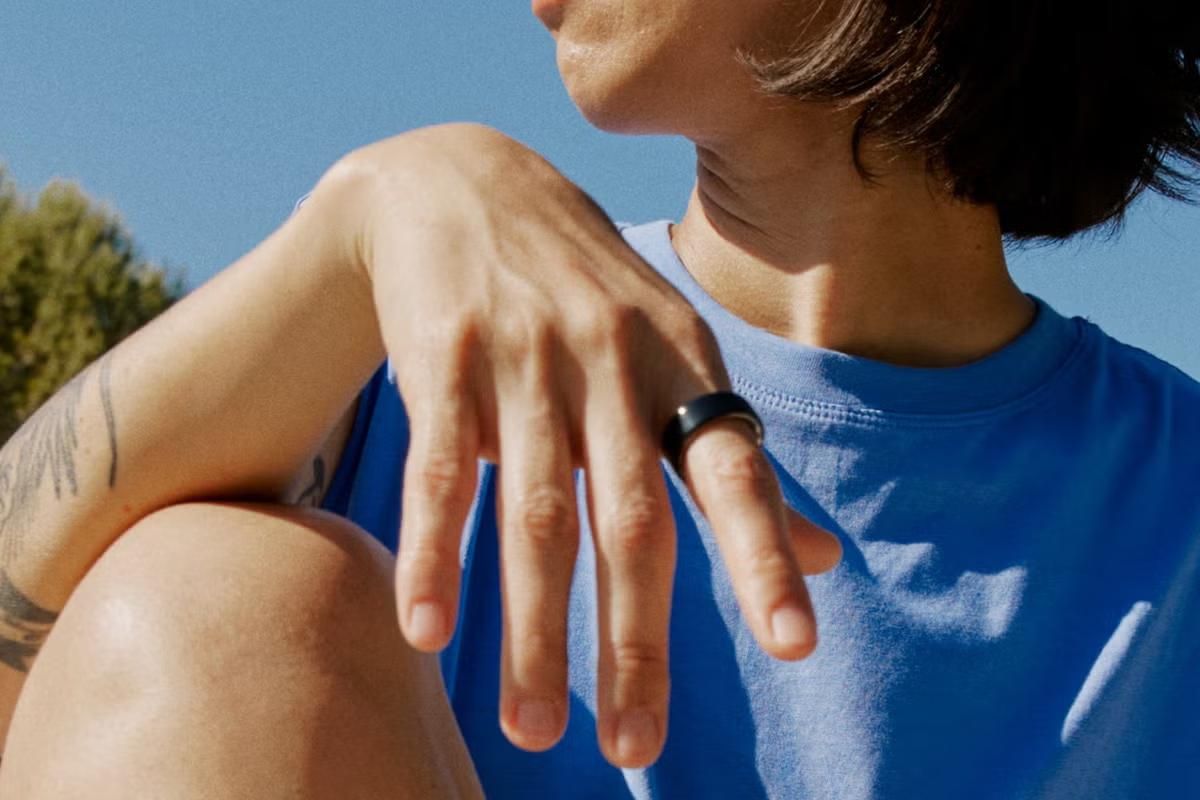 Oura Ring app, sleep score and readiness on a phone, bedside