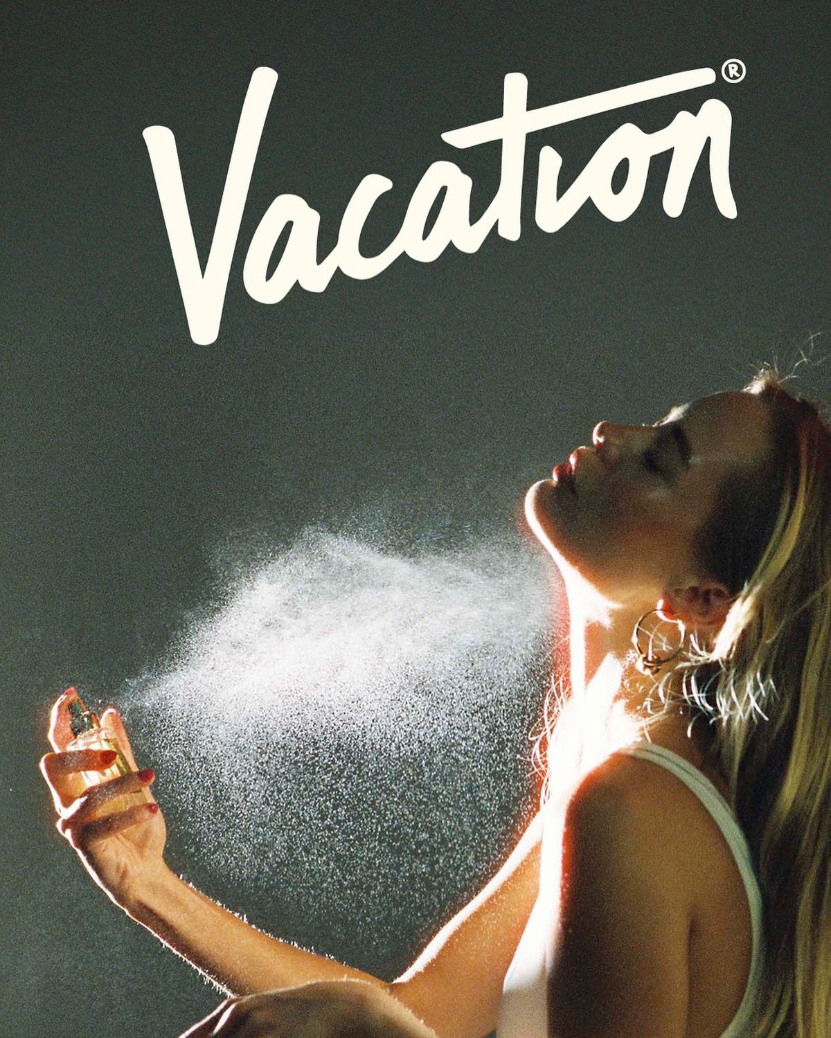 Vacation EDT perfume sprayed in a sunbeam