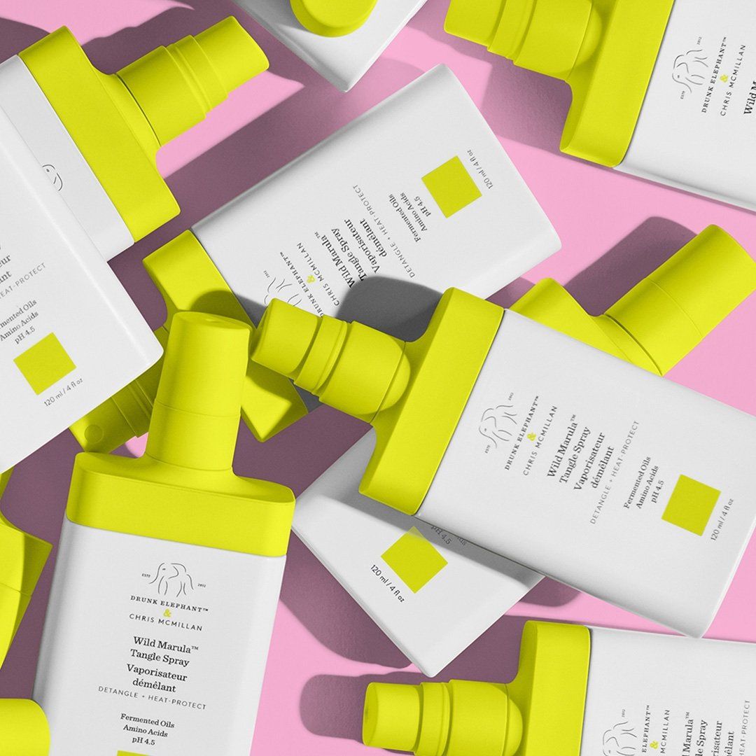 Drunk Elephant Wild Marula Tangle Spray repeating in editorial grid on hot pink, yellow caps and white bottles