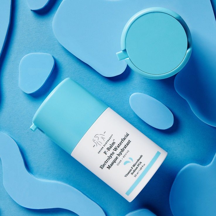 Drunk Elephant Bouncy Brightfacial mask in a repeating editorial grid on saturated yellow