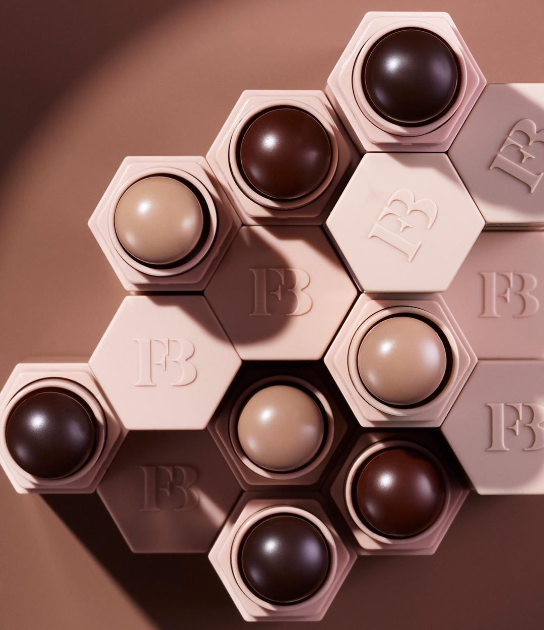 Fenty Beauty hexagonal Match Stix shade range, the brand's signature inclusive shade flatlay