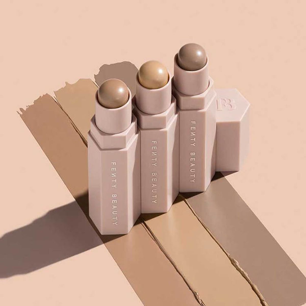 Fenty Beauty Match Stix Contour Skinsticks, three shades on beige with swatches