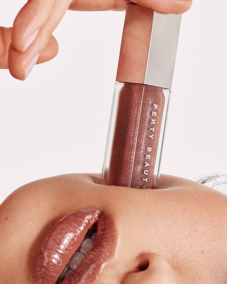 Fenty Beauty Gloss Bomb on lips, close editorial portrait, glossed nude