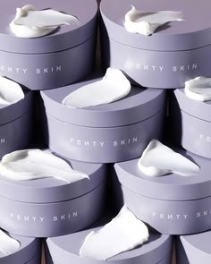 Fenty Skin lavender jars stacked with cream, editorial moisturiser still