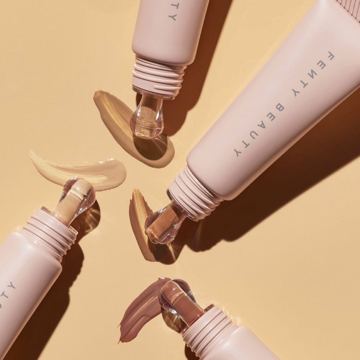 Fenty Beauty Pro Filt'r Soft Matte Longwear Foundation, flatlay on yellow with shade swatches