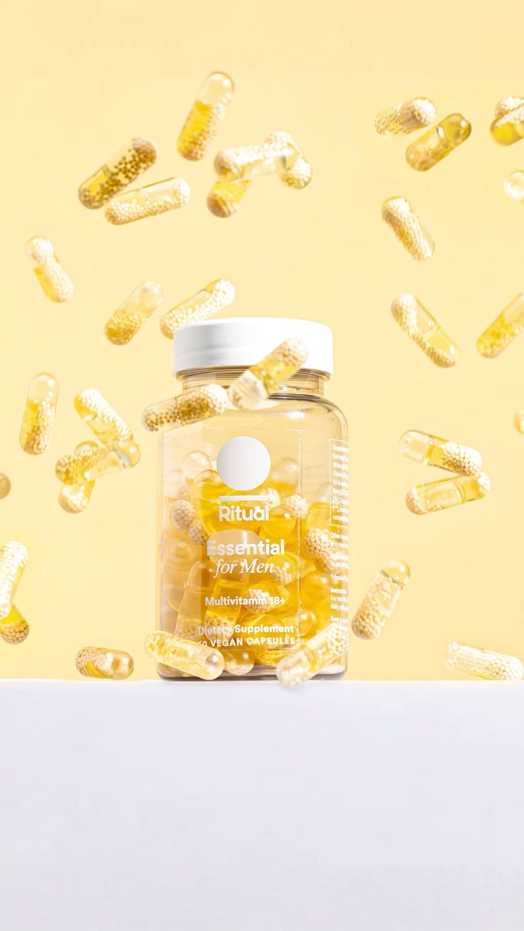 Supplements editorial, multivitamin held against capsule cloud