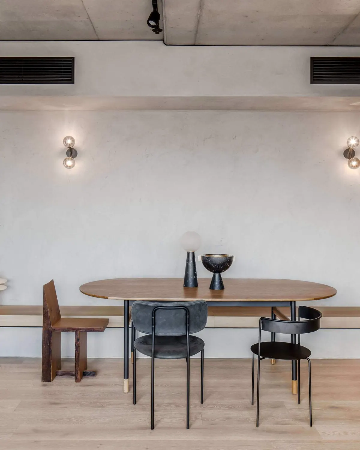 Dining area with an oval timber table and black chairs