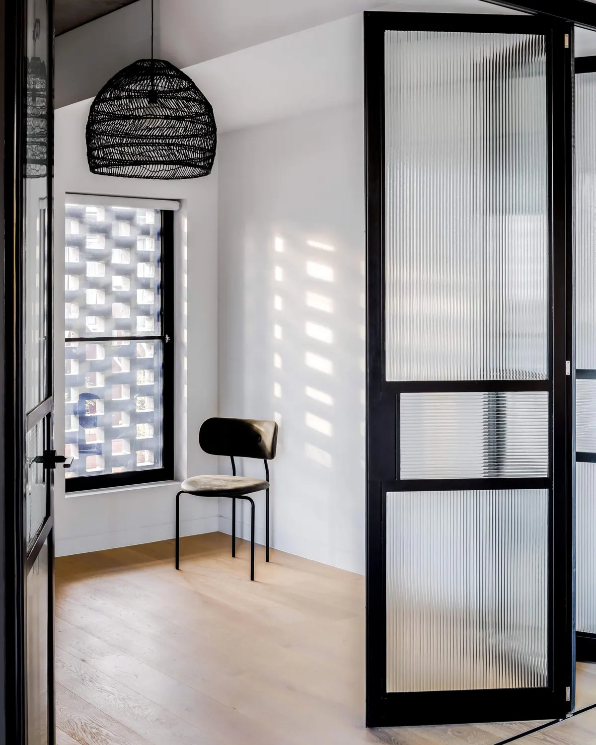 Light falling through the brick screen into a bedroom